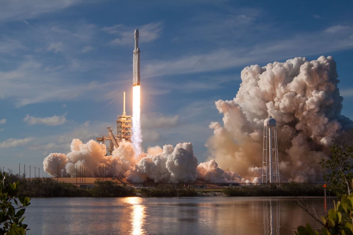 Rocket lifting off from the launch pad in a cloud of smoke