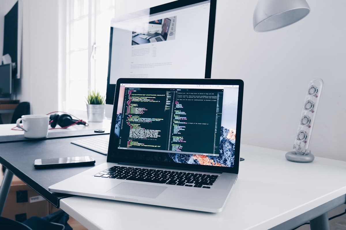 MacBook with an editor open on a bright studio desk